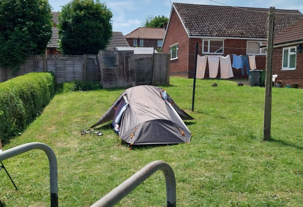A walking tent in a back garden.