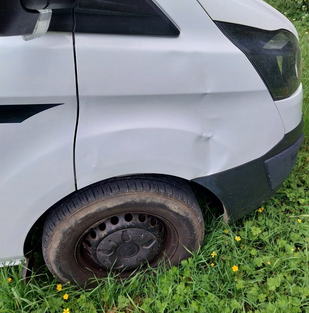 A dinted front wing on a ford transit custom van.